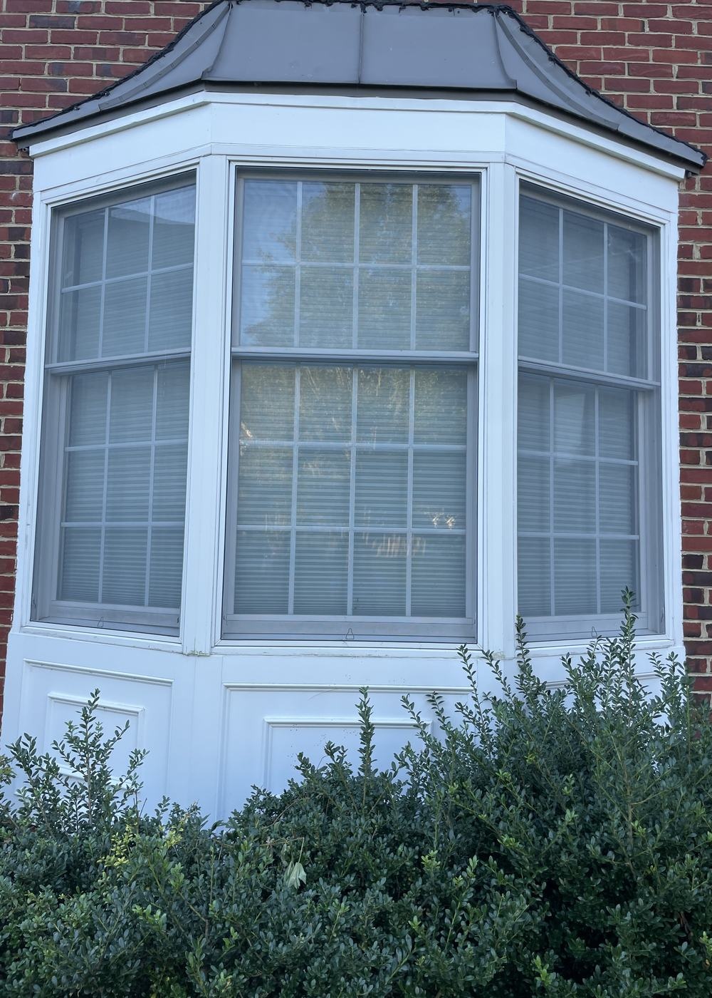 Same bay window fitted with blackout shades, after