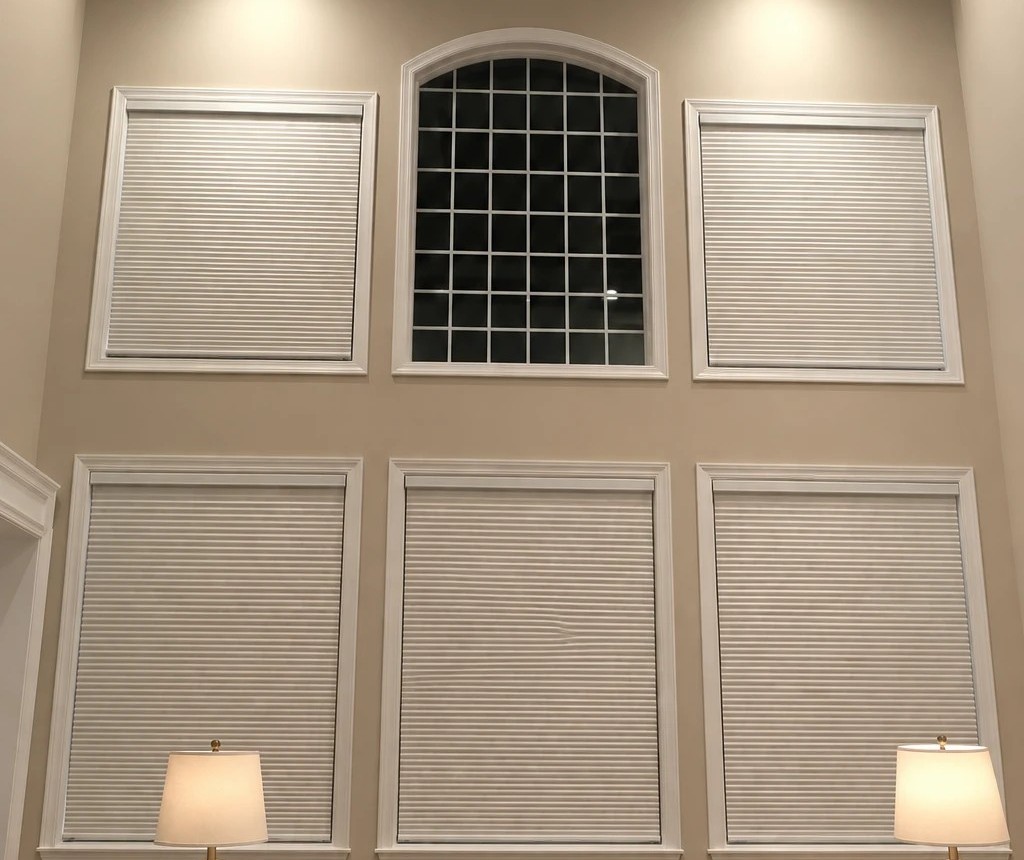 The same windows with white cellular shades; the arched top window is left open